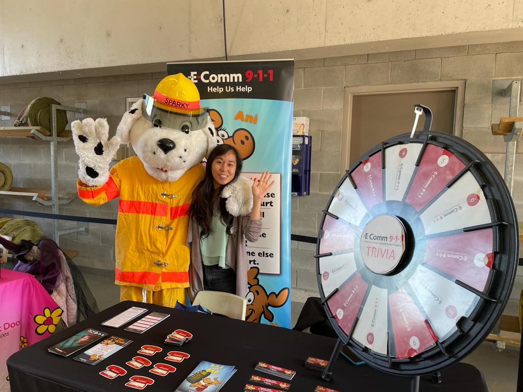 Communications Specialist Dolly and New Westminster Fire & Rescue's Fire Dog Sparky are posing for a photo at the New Westminster Fire and Rescue Services Open House on October 15.