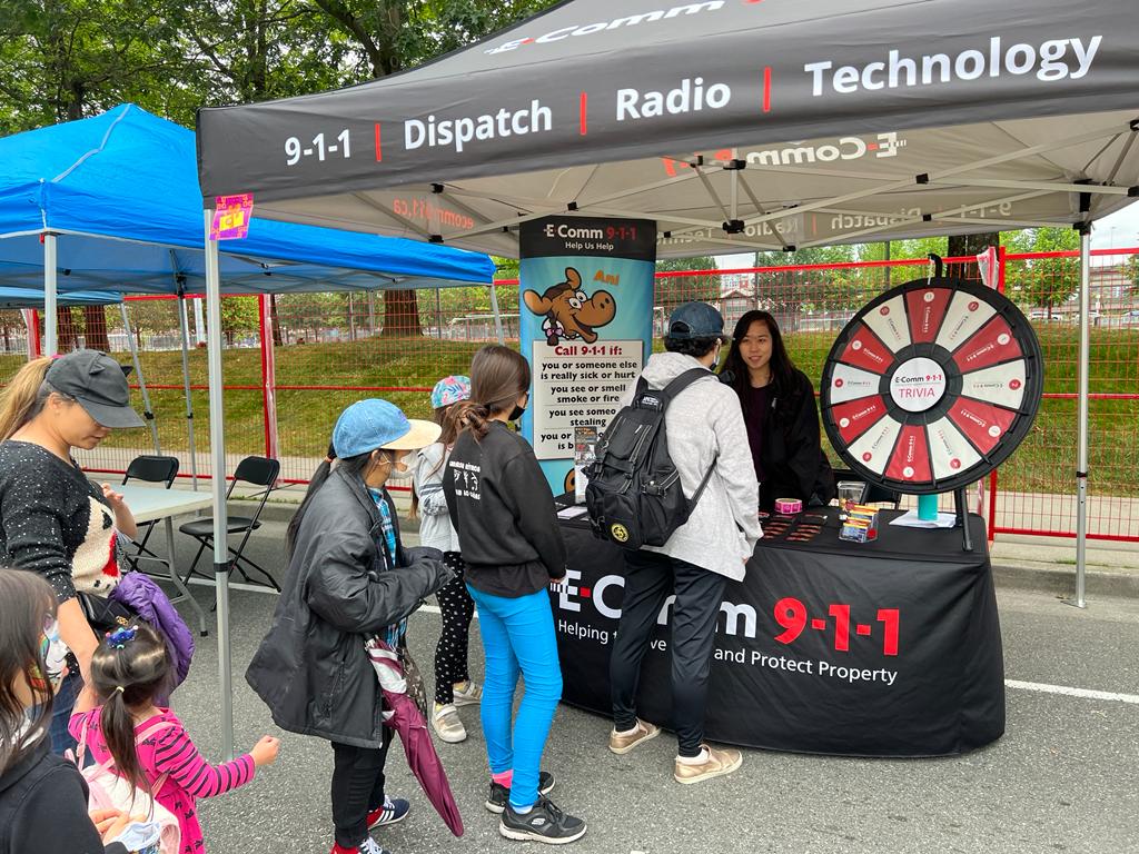 Communications Specialist Dolly Loi sharing information and 9-1-1 tips at On Your Block Fest in New Westminster on July 16.