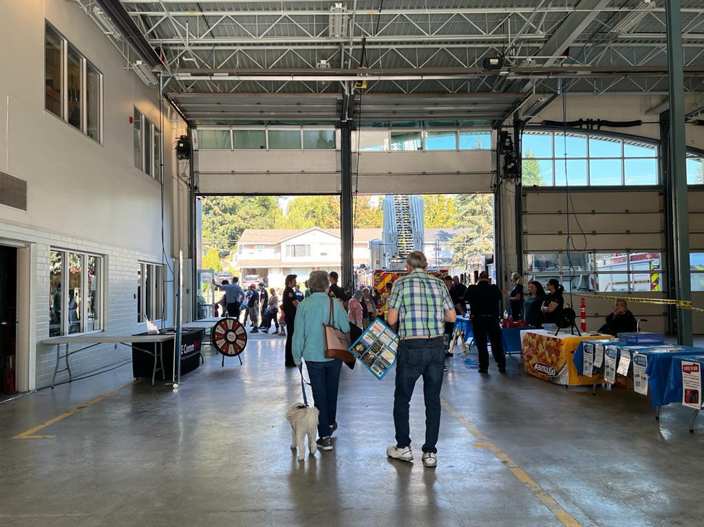We attended Mission Fire Open House on October 2 to share important 9-1-1 messaging and engage with the local communities. People are gathered at the various booths at Mission Fire & Rescue's Fire Hall on October 2.
