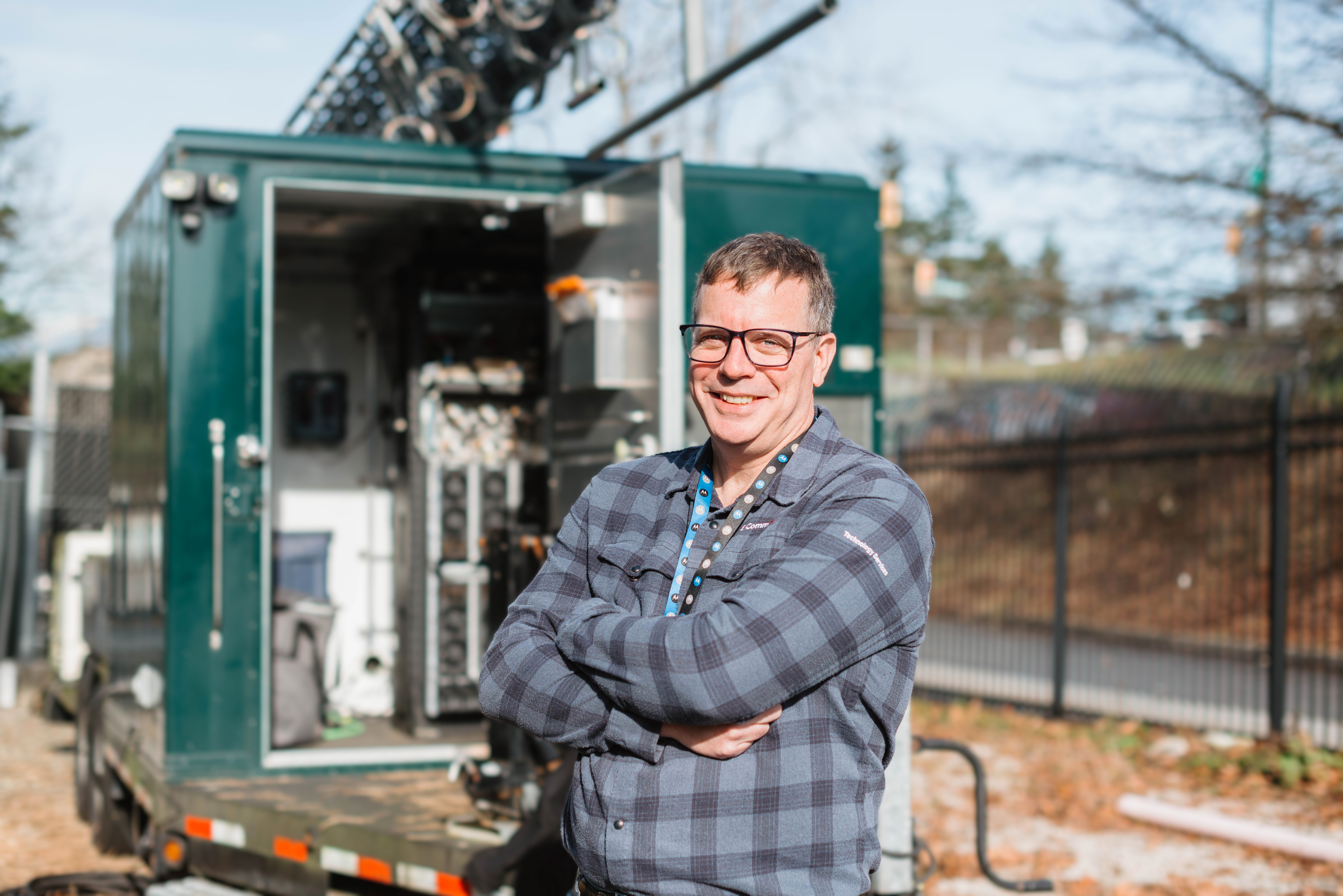 Dave Cameron stands in front of radio equipment